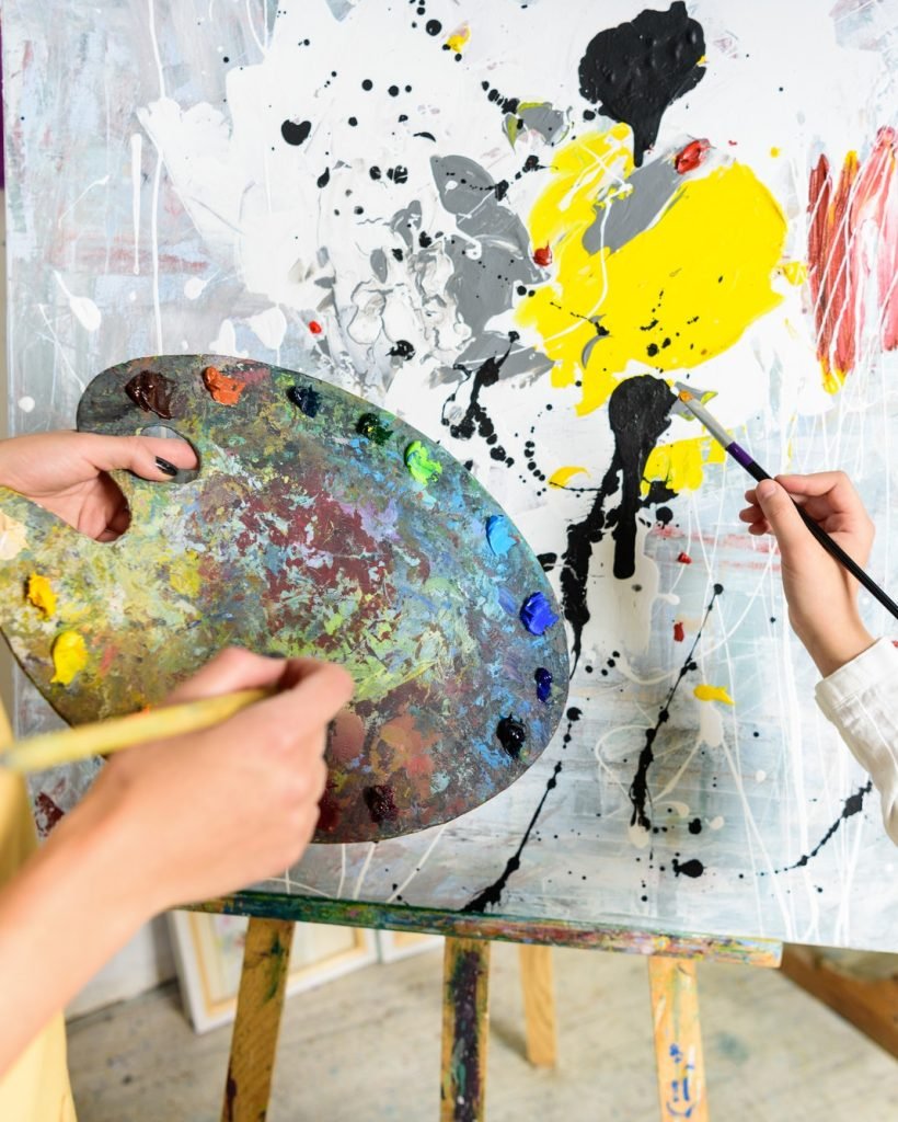 cropped-image-of-pupil-painting-on-lesson-in-workshop-of-art-school.jpg